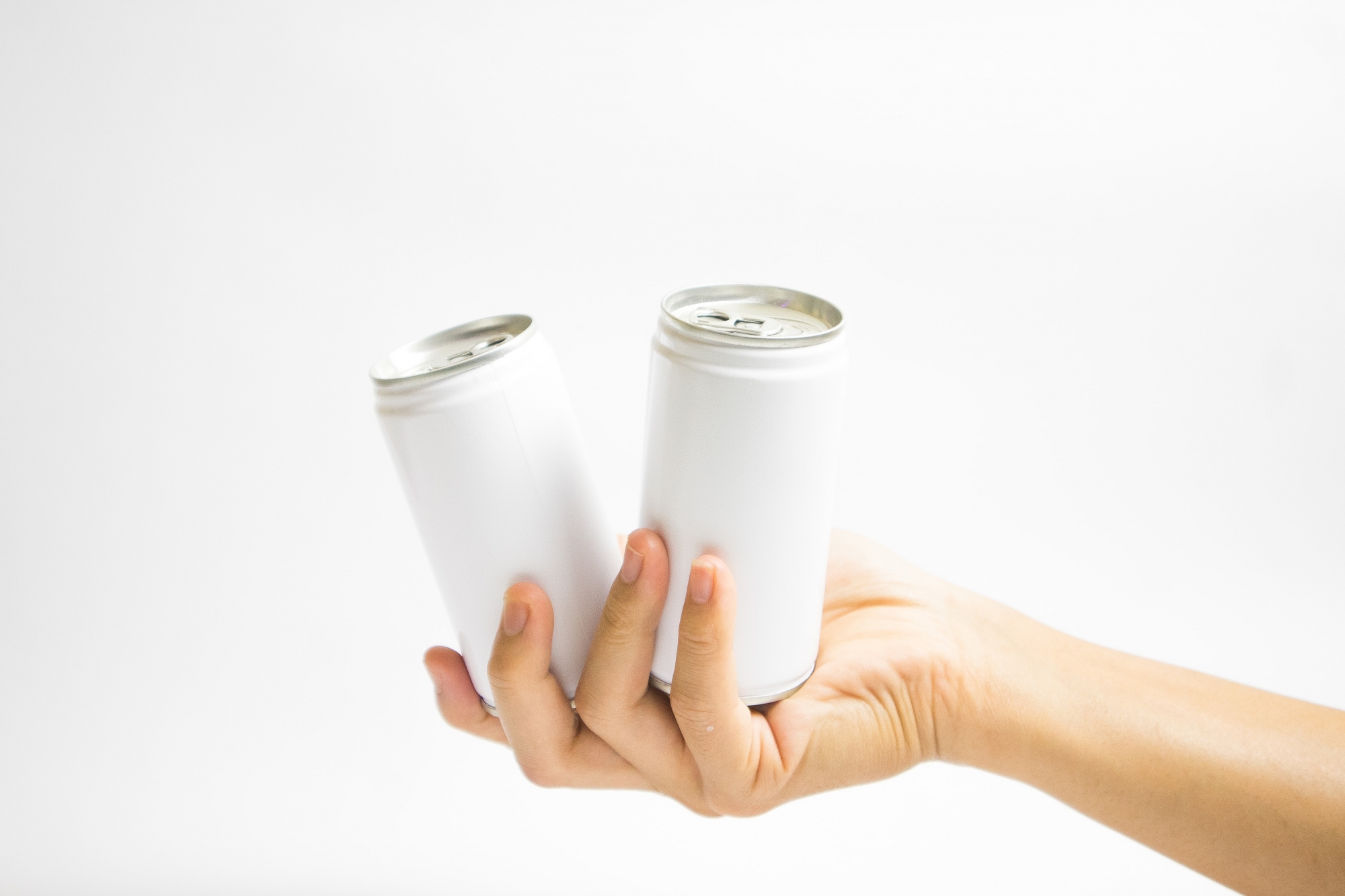 person holding to cans